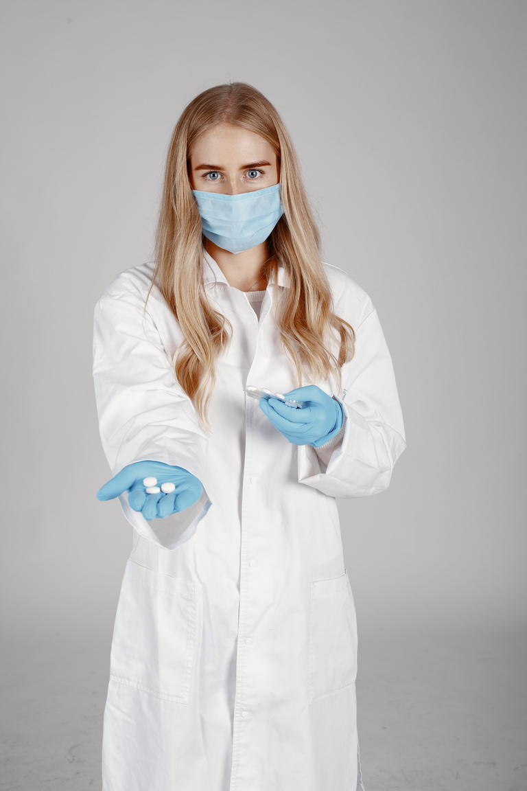 Physician Holding Pills in Hand